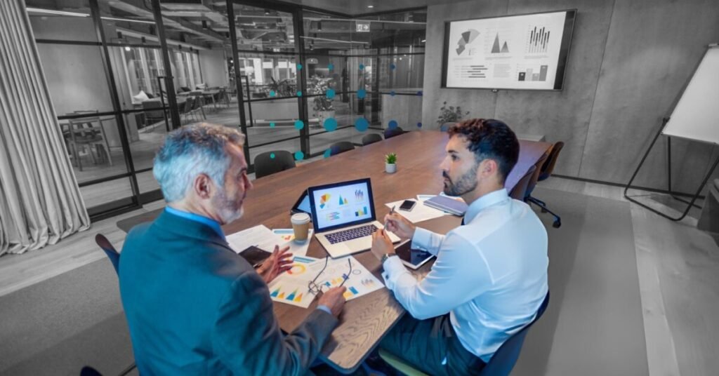 Business professionals discussing global tax compliance strategy with financial charts in office